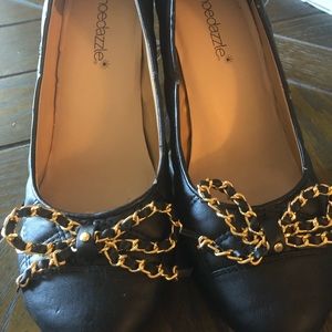 Black pumps with quilted detail stitching & bow.